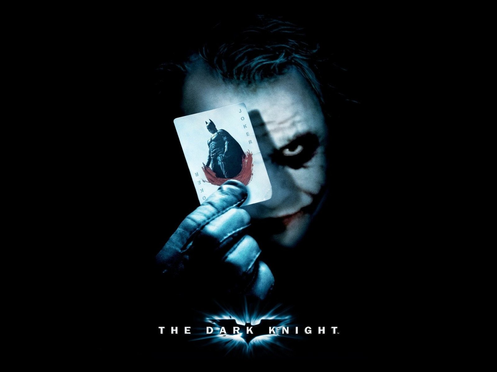 Joker holding a playing card.